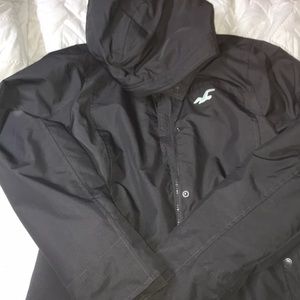 dark gray winter coat with blue details.